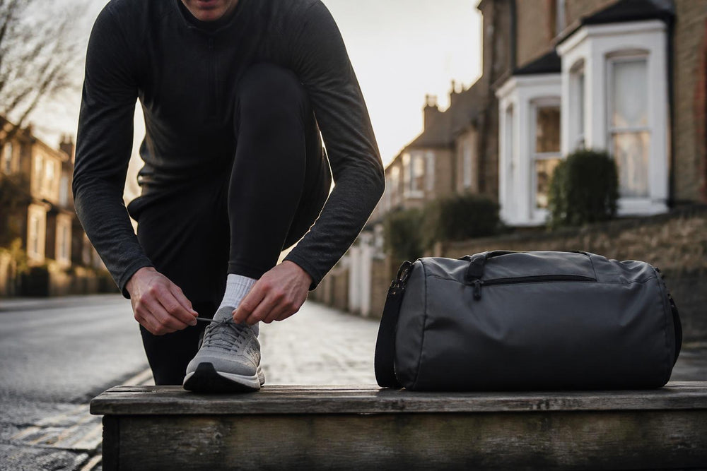 A sleek running backpack resting on a wooden bench in a sunlit park