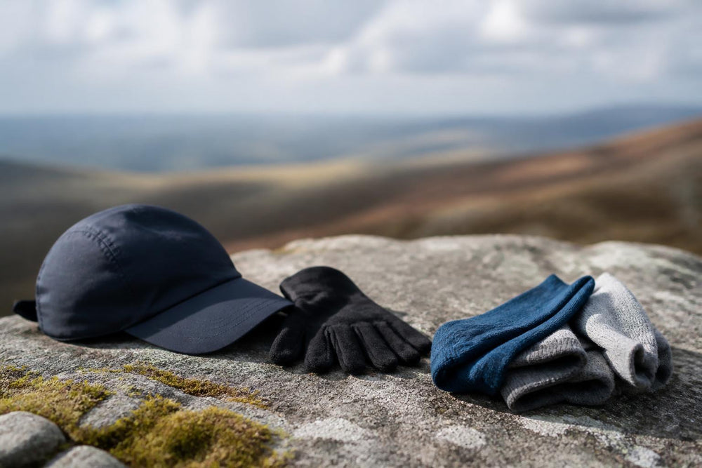 A flat lay of running shoes, a water bottle, and a sports watch arranged neatly on a grey surface