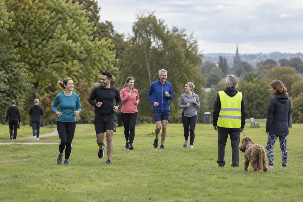 Illustrative group of runners and walkers in a park, not a photograph of a specific event